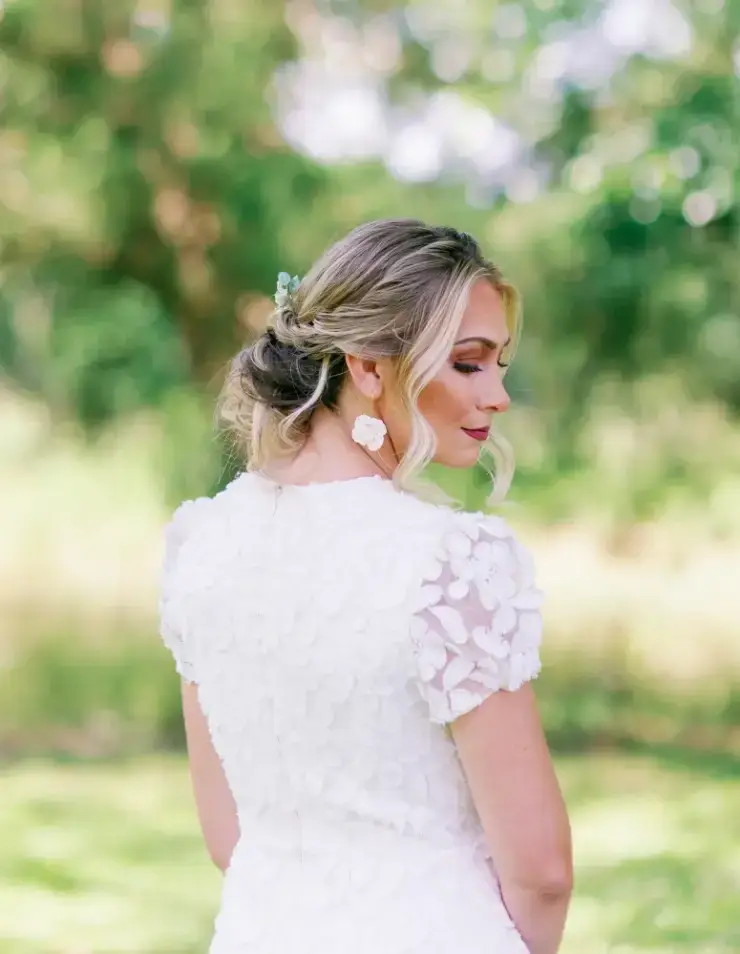 model is wearing a short sleeve a-line wedding dress