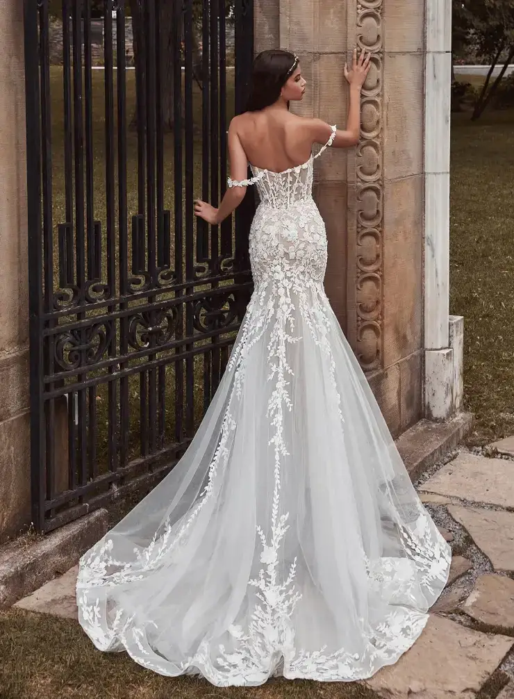model is wearing an off the shoulder lace trumpet wedding dress