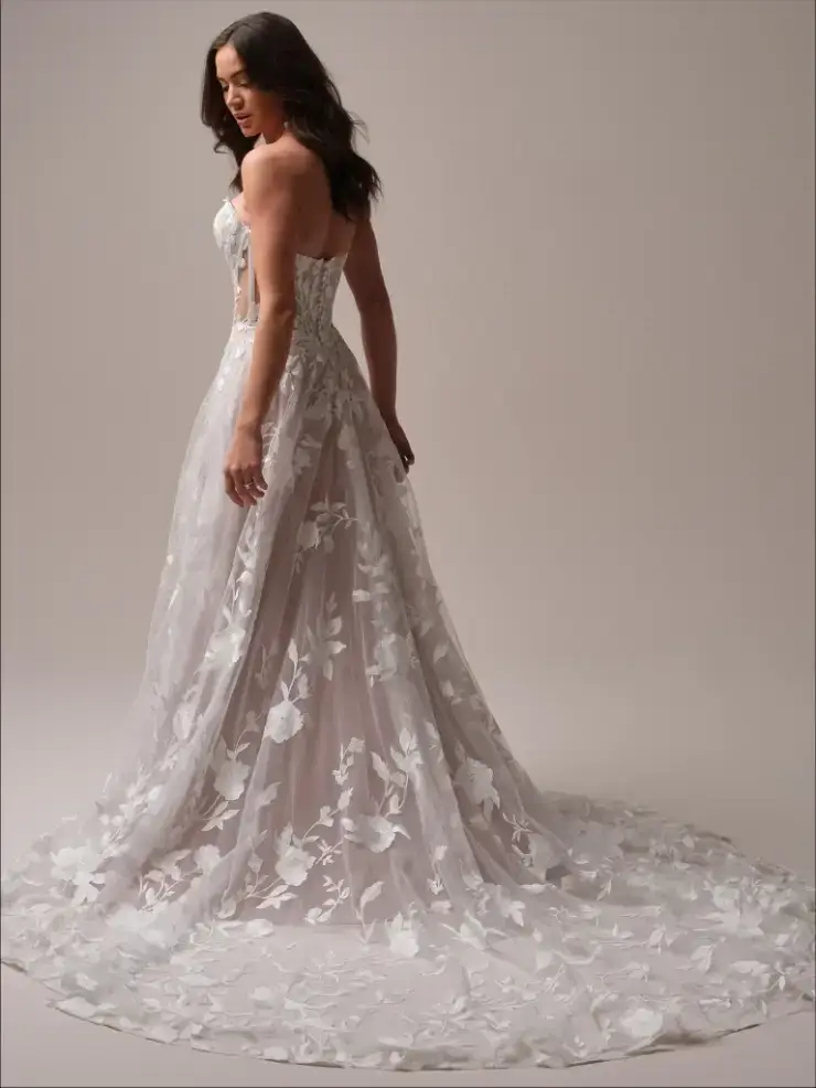 model is wearing a lace a-line bridal gown