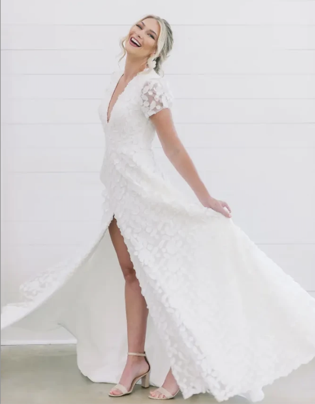 model is wearing a short sleeve a-line wedding dress
