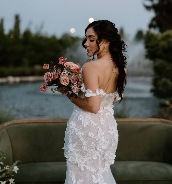 Model wearing a white dress with flowers