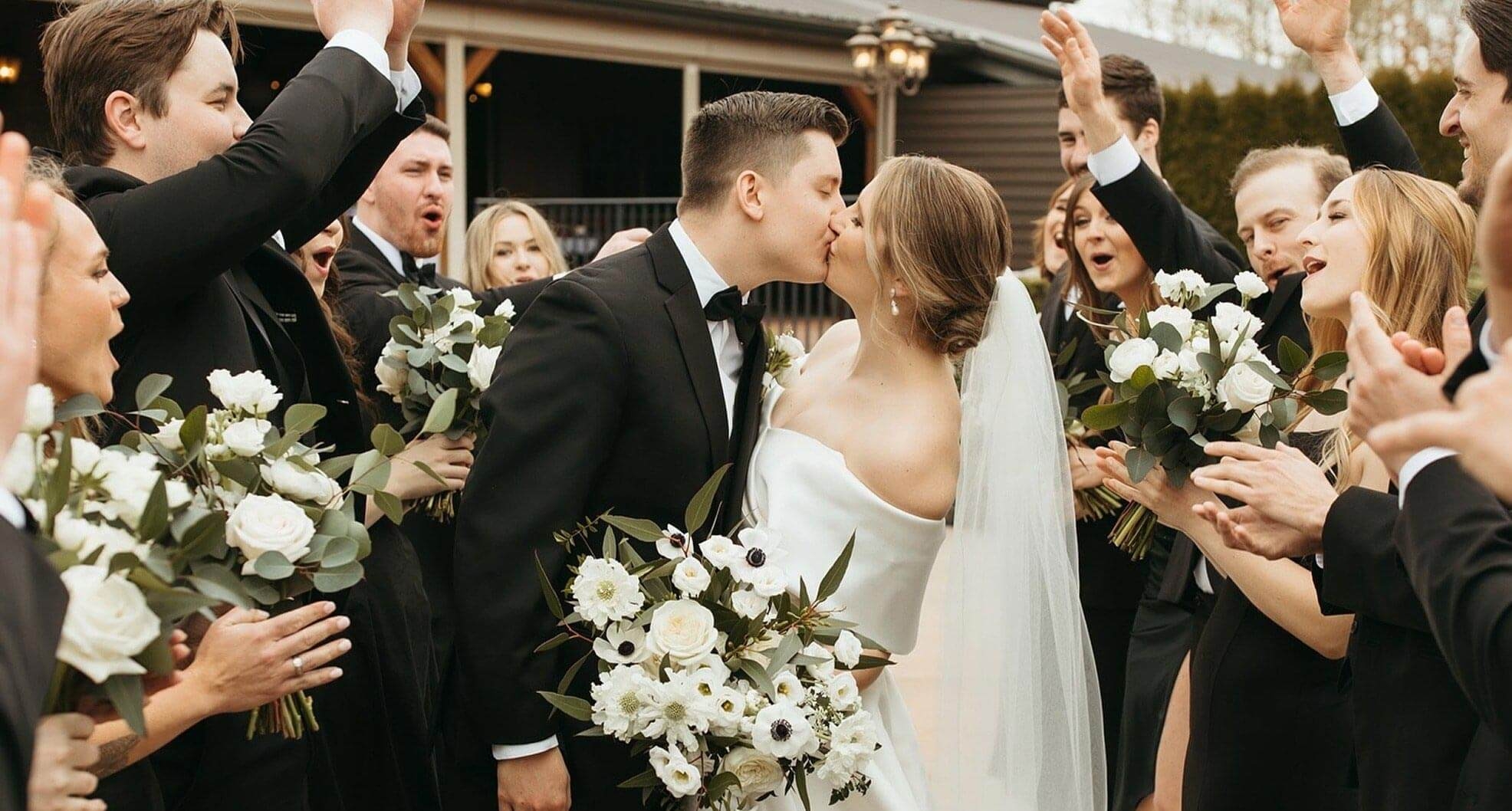 Сouple wearing a white gown and a black suit